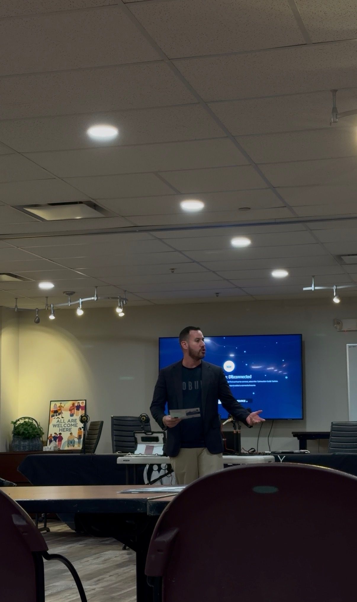 Dr. Robbie Westerman presenting in a meeting room